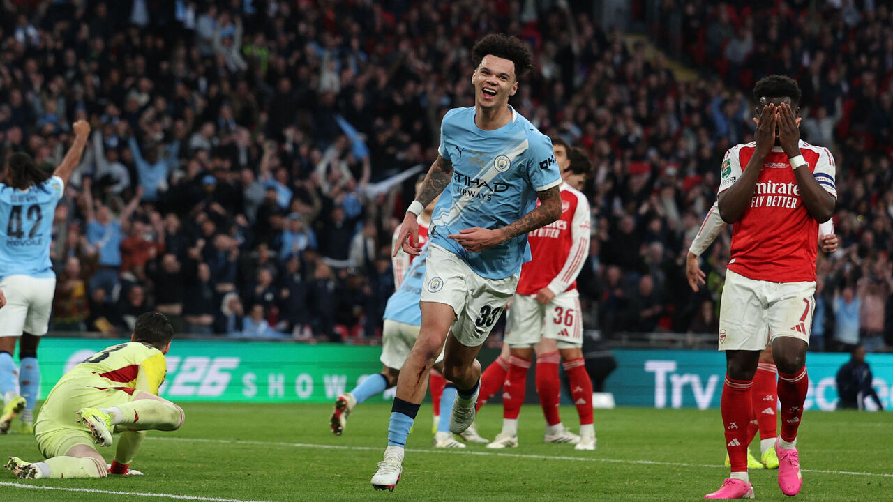 Arsenal's English midfielder #07 Bukayo Saka (R) reacts as Manchester City's English midfielder #33 Nico O'Reilly (C) celebrates scoring their second goal during the English League Cup final football match between Arsenal and Manchester City at Wembley Stadium in London on March 22, 2026. / RESTRICTED TO EDITORIAL USE. No use with unauthorized audio, video, data, fixture lists, club/league logos or 'live' services. Online in-match use limited to 120 images. An additional 40 images may be used in extra time. No video emulation. Social media in-match use limited to 120 images. An additional 40 images may be used in extra time. No use in betting publications, games or single club/league/player publications. /