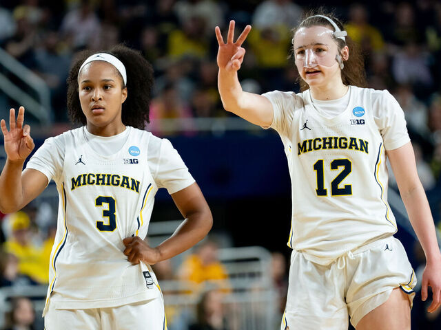 ANN ARBOR, MICHIGAN - MARCH 22: Mila Holloway #3 and Syla Swords #12 of the Michigan Wolverines display hand signals to their teammates during the first half against the NC State Wolfpack in the Second Round of the 2026 NCAA Women's Basketball Tournament at Crisler Arena on March 22, 2026 in Ann Arbor, Michigan.