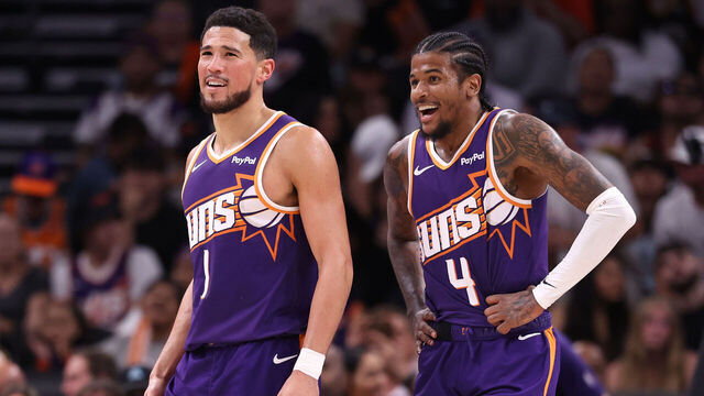 PHOENIX, ARIZONA - MARCH 22: Devin Booker #1 and Jalen Green #4 of the Phoenix Suns react after a basket during the second half against the Toronto Raptors at Mortgage Matchup Center on March 22, 2026 in Phoenix, Arizona.