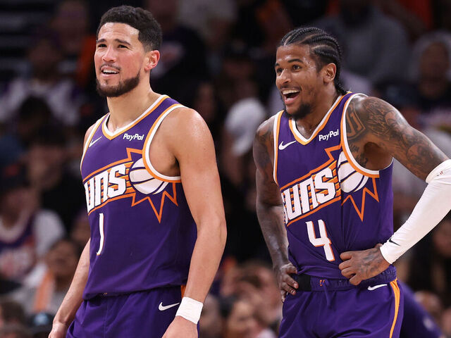 PHOENIX, ARIZONA - MARCH 22: Devin Booker #1 and Jalen Green #4 of the Phoenix Suns react after a basket during the second half against the Toronto Raptors at Mortgage Matchup Center on March 22, 2026 in Phoenix, Arizona.