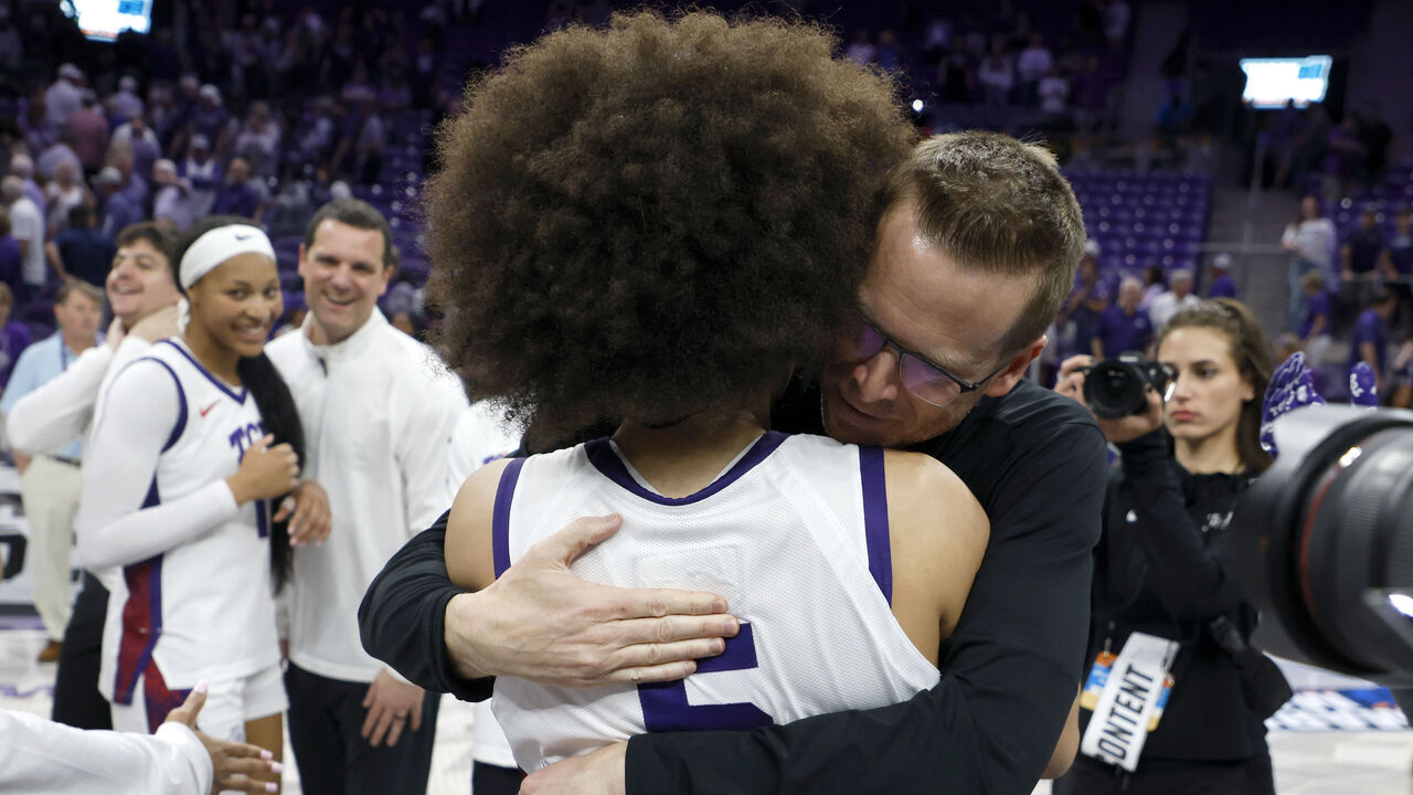 FORT WORTH, TEXAS - MARCH 22: Head coach Mark Campbell of the TCU Horned Frogs celebrates with Olivia Miles #5 of the TCU Horned Frogs following the team's overtime victory over the Washington Huskies in the Second Round of the NCAA Women's Basketball Tournament on March 22, 2026 at Schollmaier Arena in Fort Worth, Texas.