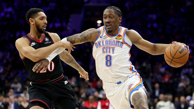 PHILADELPHIA, PENNSYLVANIA - MARCH 23: Jalen Williams #8 of the Oklahoma City Thunder drives past Cameron Payne #20 of the Philadelphia 76ers during the first half at Xfinity Mobile Arena on March 23, 2026 in Philadelphia, Pennsylvania.