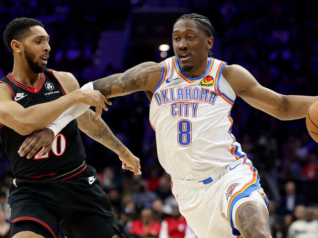 PHILADELPHIA, PENNSYLVANIA - MARCH 23: Jalen Williams #8 of the Oklahoma City Thunder drives past Cameron Payne #20 of the Philadelphia 76ers during the first half at Xfinity Mobile Arena on March 23, 2026 in Philadelphia, Pennsylvania.