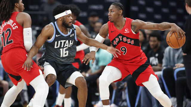 SALT LAKE CITY, UT - MARCH 23: Elijah Harkless #16 of the Utah Jazz tries to get to RJ Barrett #9 of the Toronto Raptors as Collin Murray-Bowles #12 sets a pick during the first half of their game at the Delta Center on March 23, 2026 in Salt Lake City, Utah.