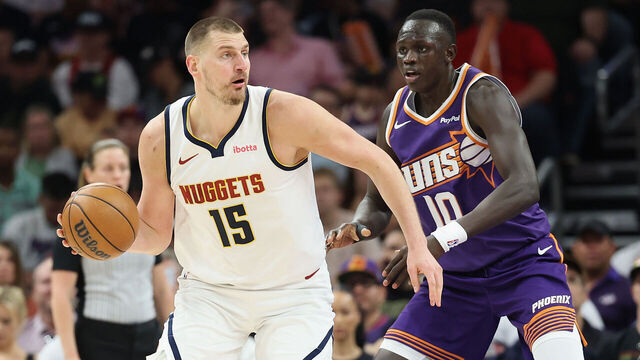 PHOENIX, ARIZONA - MARCH 24: Nikola Jokic #15 of the Denver Nuggets handles the ball against Khaman Maluach #10 of the Phoenix Suns during the first half of the NBA game at Mortgage Matchup Center on March 24, 2026 in Phoenix, Arizona.