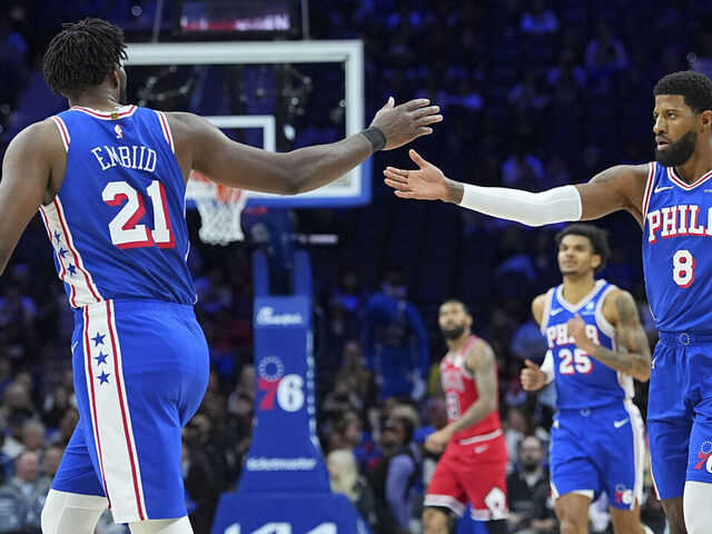 PHILADELPHIA, PENNSYLVANIA - MARCH 25: Joel Embiid #21 of the Philadelphia 76ers celebrates with Paul George #8 against the Chicago Bulls in the first quarter at Xfinity Mobile Arena on March 25, 2026 in Philadelphia, Pennsylvania.