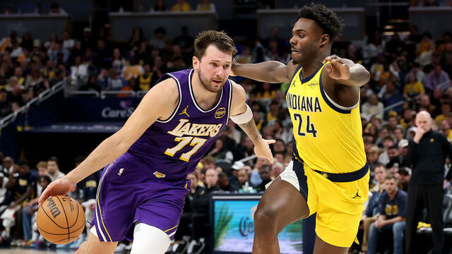 INDIANAPOLIS, INDIANA - MARCH 25: Luka Doncic #77 of the Los Angeles Lakers dribbles the ball while defended by Kobe Brown #24 of the Indiana Pacers at Gainbridge Fieldhouse on March 25, 2026 in Indianapolis, Indiana.