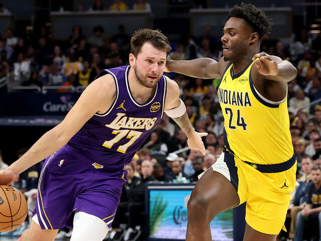 INDIANAPOLIS, INDIANA - MARCH 25: Luka Doncic #77 of the Los Angeles Lakers dribbles the ball while defended by Kobe Brown #24 of the Indiana Pacers at Gainbridge Fieldhouse on March 25, 2026 in Indianapolis, Indiana.
