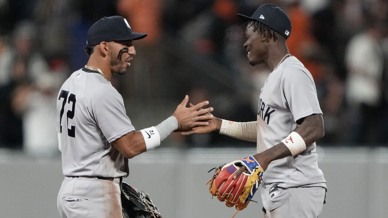 SAN FRANCISCO, CALIFORNIA - MARCH 25: José Caballero #72 and Jazz Chisholm Jr. #13 of the New York Yankees embrace after defeating the San Francisco Giants on Opening Day at Oracle Park on March 25, 2026 in San Francisco, California.