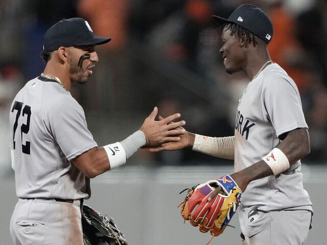 SAN FRANCISCO, CALIFORNIA - MARCH 25: José Caballero #72 and Jazz Chisholm Jr. #13 of the New York Yankees embrace after defeating the San Francisco Giants on Opening Day at Oracle Park on March 25, 2026 in San Francisco, California.