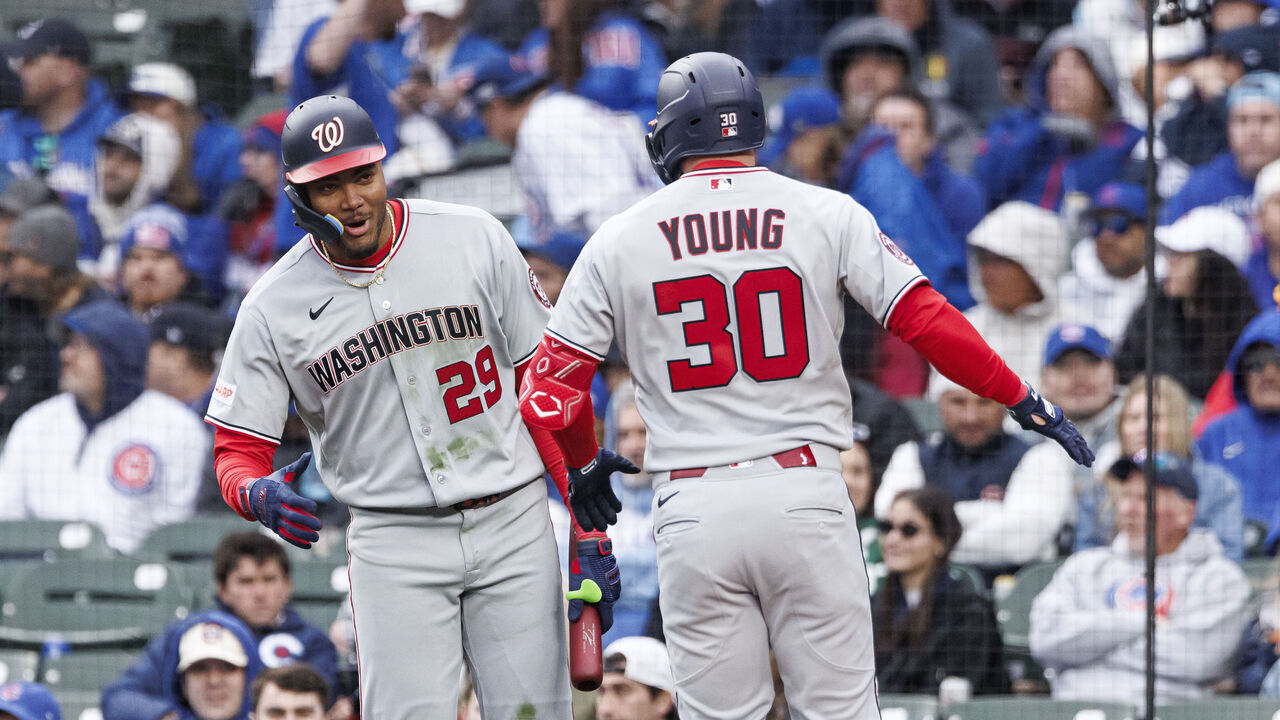 CHICAGO, ILLINOIS - MARCH 26: James Wood #29 of the Washington Nationals reacts with Jacob Young #30 of the Washington Nationals after hitting a two-run home run in the fourth inning of a game between the Washington Nationals and the Chicago Cubs on Opening Day at Wrigley Field on March 26, 2026 in Chicago, Illinois.