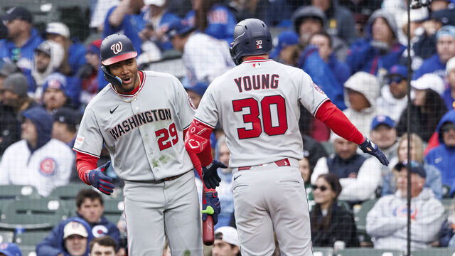 CHICAGO, ILLINOIS - MARCH 26: James Wood #29 of the Washington Nationals reacts with Jacob Young #30 of the Washington Nationals after hitting a two-run home run in the fourth inning of a game between the Washington Nationals and the Chicago Cubs on Opening Day at Wrigley Field on March 26, 2026 in Chicago, Illinois.