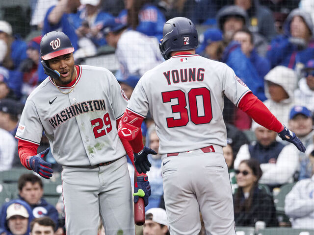 CHICAGO, ILLINOIS - MARCH 26: James Wood #29 of the Washington Nationals reacts with Jacob Young #30 of the Washington Nationals after hitting a two-run home run in the fourth inning of a game between the Washington Nationals and the Chicago Cubs on Opening Day at Wrigley Field on March 26, 2026 in Chicago, Illinois.