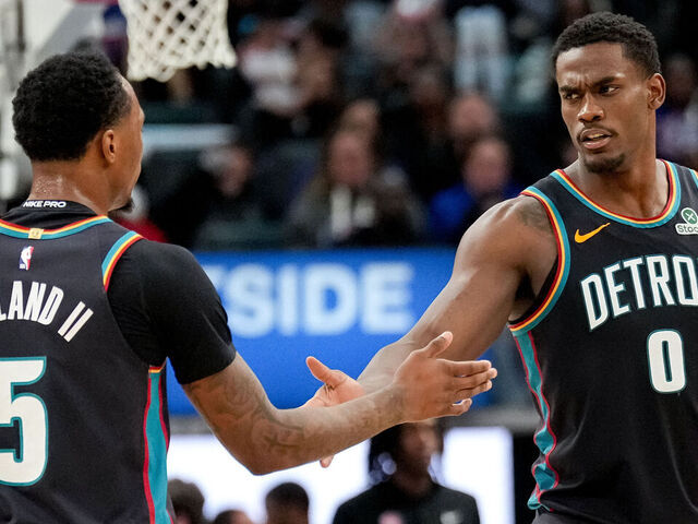 DETROIT, MICHIGAN - MARCH 26: Ronald Holland II #5 high fives Jalen Duren #0 of the Detroit Pistons during the second quarter against the New Orleans Pelicans at Little Caesars Arena on March 26, 2026 in Detroit, Michigan.