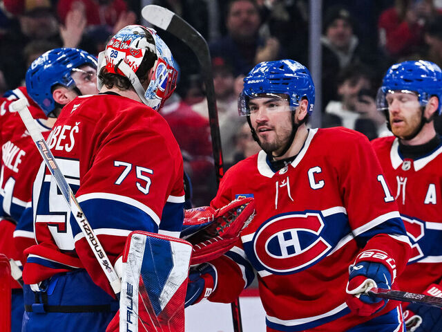MONTREAL, QC - MARCH 26: Montreal Canadiens center Nick Suzuki (14) celebrates with goalie Jakub Dobes (75) the win after the Columbus Blue Jackets versus the Montreal Canadiens game on March 26, 2026, at Bell Centre in Montreal, QC