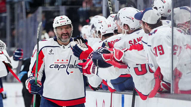 SALT LAKE CITY, UTAH - MARCH 26: Alex Ovechkin #8 of the Washington Capitals high-fives his teammates after scoring an empty net hat-trick goal in the third period of a game against the Utah Mammoth at Delta Center on March 26, 2026 in Salt Lake City, Utah.