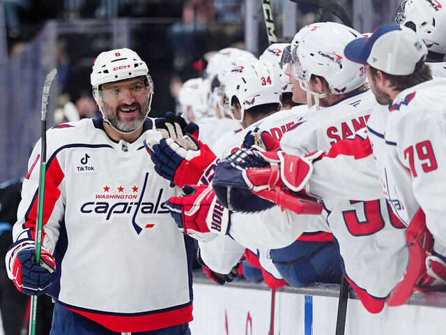 SALT LAKE CITY, UTAH - MARCH 26: Alex Ovechkin #8 of the Washington Capitals high-fives his teammates after scoring an empty net hat-trick goal in the third period of a game against the Utah Mammoth at Delta Center on March 26, 2026 in Salt Lake City, Utah.