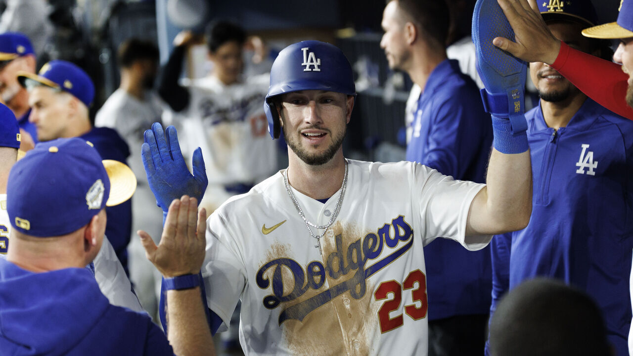 LOS ANGELES, CA - MARCH 26, 2026: Los Angeles Dodgers right fielder Kyle Tucker (23) gets high-fives in the dugout after scoring on an RBI single against the Arizona Diamondbacks in the seventh inning at Dodger Stadium on March 26, 2026 in Los Angeles, CA.(Gina Ferazzi / Los Angeles Times via Getty Images)