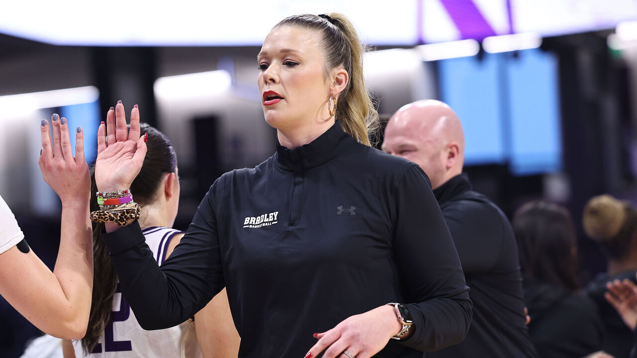 EVANSTON, ILLINOIS - DECEMBER 15: Head coach Kate Popovec-Goss of the Bradley Braves high fives players after a non-conference game against the Northwestern Wildcats at Welsh-Ryan Arena on December 15, 2024 in Evanston, Illinois.