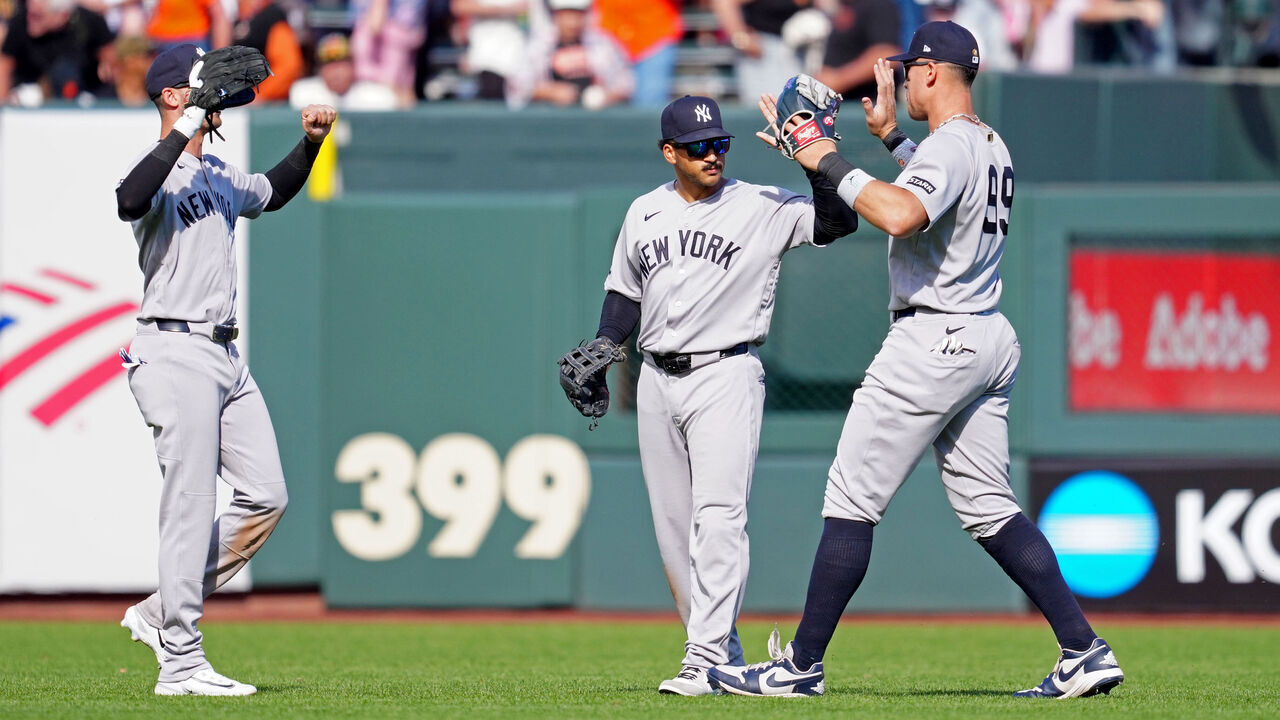SAN FRANCISCO, CA - MARCH 27: Aaron Judge #99, Trent Grisham #12 and Cody Bellinger #35 of the New York Yankees celebrate after the Yankees defeated the San Francisco Giants in the game at Oracle Park on Friday, March 27, 2026 in San Francisco, California.