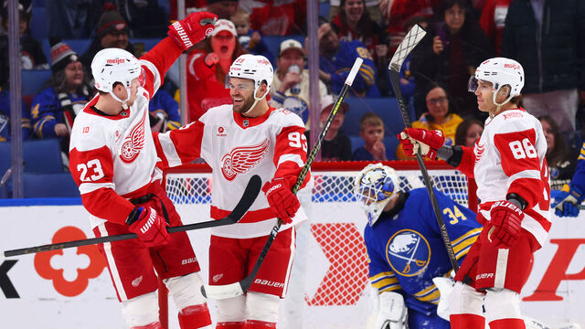 BUFFALO, NEW YORK - MARCH 27: Alex DeBrincat #93 of the Detroit Red Wings celebrates his first period goal against Alex Lyon #34 of the Buffalo Sabres with Lucas Raymond #23 and Patrick Kane #88 during an NHL game on March 27, 2026 at KeyBank Center in Buffalo, New York.