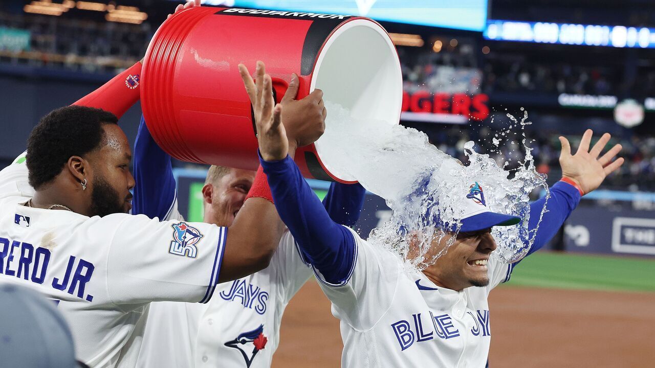 TORONTO, ON- MARCH 27 - First baseman Vladimir Guerrero Jr. #27 of the Toronto Blue Jays and Myles Straw #3 of the Toronto Blue Jays douse second baseman Andrés Giménez #0 of the Toronto Blue Jays in ice water after he had all three Toronto Blue Jays RBI's as the Toronto Blue Jays beat the Athletics in the season opener 3-2 at Rogers Centre in Toronto. March 27, 2026. Steve Russell/Toronto Star (Steve Russell/Toronto Star via Getty Images)