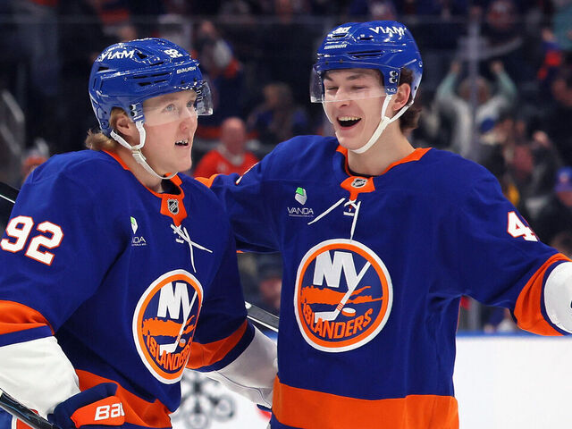 ELMONT, NEW YORK - MARCH 28: Simon Holmstrom #92 of the New York Islanders (l) celebrates his powerplay goal against the Florida Panthers at 14:52 of the second period and is joined by Matthew Schaefer #48 (r) at UBS Arena on March 28, 2026 in Elmont, New York.