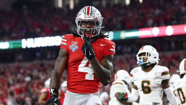 ARLINGTON, TEXAS - DECEMBER 31: Jeremiah Smith #4 of the Ohio State Buckeyes reacts after scoring a touchdown against the Miami Hurricanes during the second half of the College Football Playoff Quarter Final Game at AT&T Stadium on December 31, 2025 in Arlington, Texas.