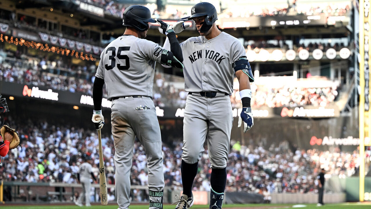 SAN FRANCISCO, CALIFORNIA - MARCH 28: Aaron Judge #99 of the New York Yankees celebrates with Cody Bellinger after hitting a home run against the San Francisco Giants in the fifth inning at Oracle Park on March 28, 2026 in San Francisco, California.