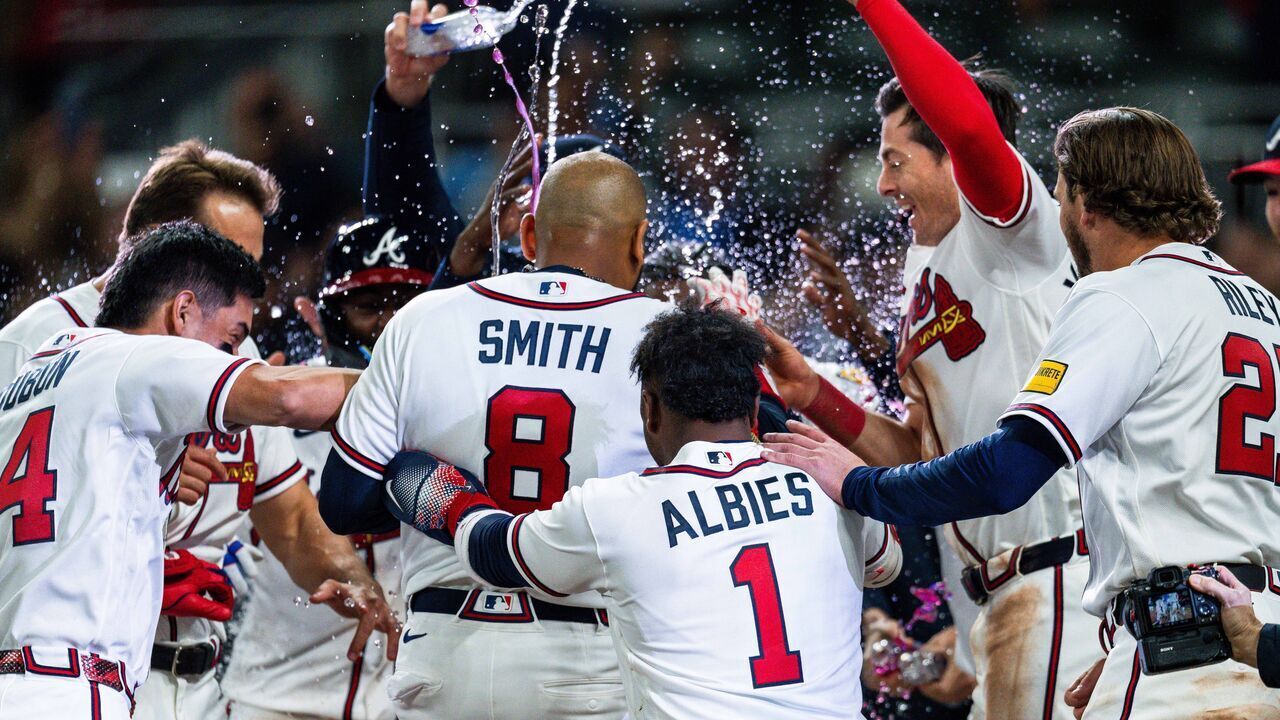 ATLANTA, GA - MARCH 28: Dominic Smith #8 of the Atlanta Braves celebrates with teammates after hitting a walk off grand slam in the ninth inning during the game against the Kansas City Royals at Truist Park on March 28, 2026 in Atlanta, Georgia.