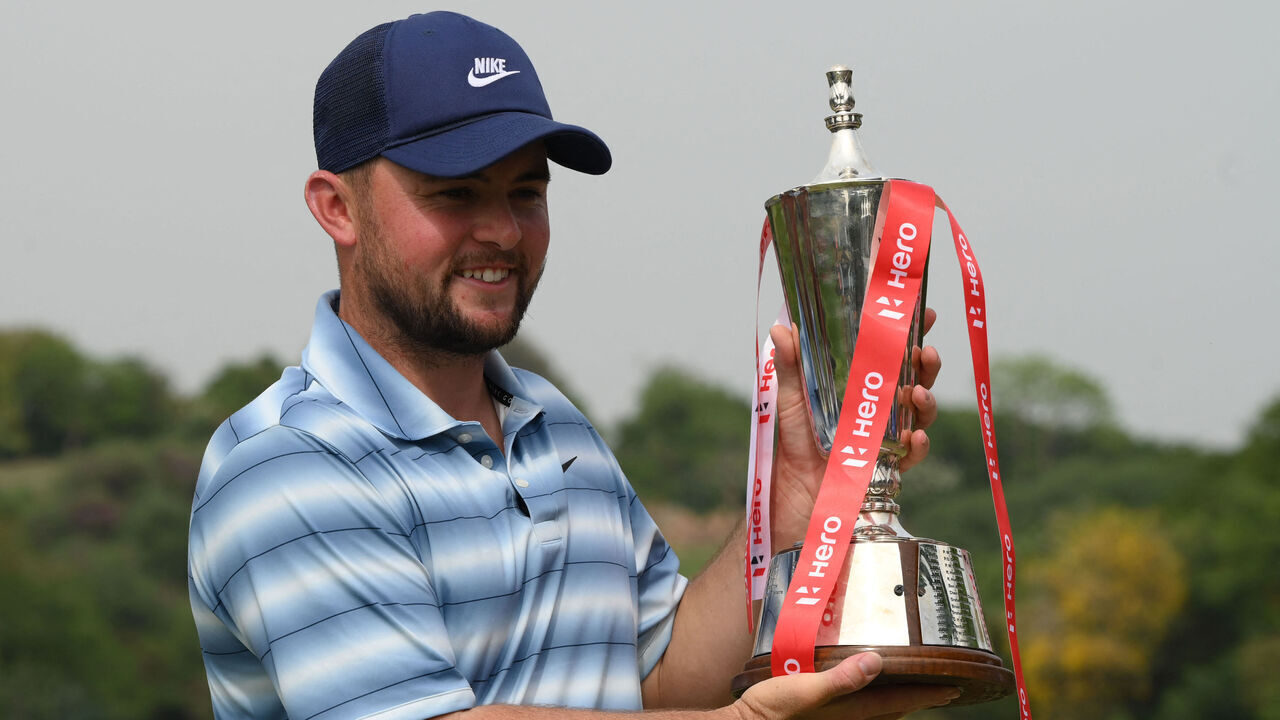 England's Alex Fitzpatrick poses with the trophy after winning the Indian Open golf tournament of DP World Tour in Gurgaon on March 29, 2026.