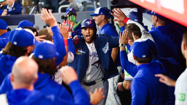 TORONTO, CANADA - MARCH 29: George Springer #4 of the Toronto Blue Jays celebrates in the dugout after hitting a solo-home run in the first inning of their MLB game against the Athletics at Rogers Centre on March 29, 2026 in Toronto, Ontario, Canada.