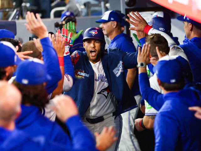 TORONTO, CANADA - MARCH 29: George Springer #4 of the Toronto Blue Jays celebrates in the dugout after hitting a solo-home run in the first inning of their MLB game against the Athletics at Rogers Centre on March 29, 2026 in Toronto, Ontario, Canada.