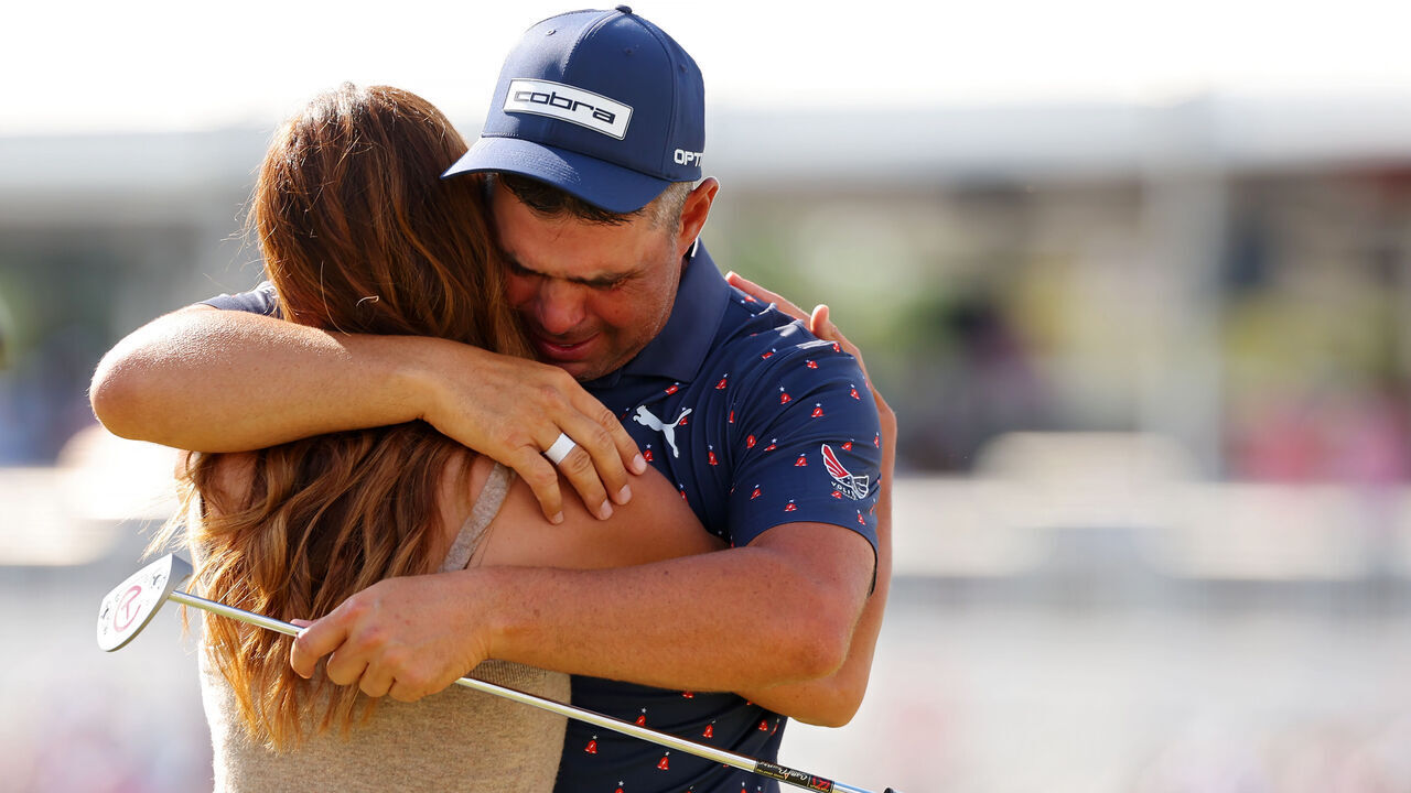 HOUSTON, TEXAS - MARCH 29: Gary Woodland of the United States embraces wife Gabby Granado on the 18th green after winning the Texas Children's Houston Open 2026 at Memorial Park Golf Course on March 29, 2026 in Houston, Texas.