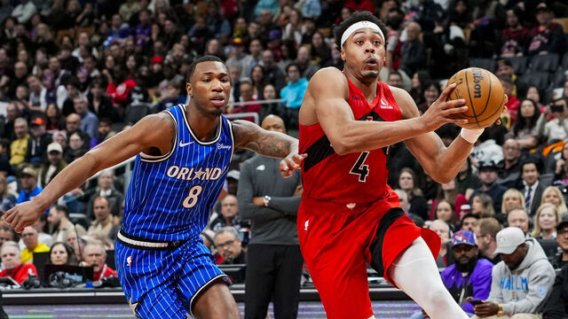 TORONTO, CANADA - MARCH 29: Scottie Barnes #4 of the Toronto Raptors drives to the basket against Jamal Cain #8 of the Orlando Magic during the second half at Scotiabank Arena on March 29, 2026 in Toronto, Canada.