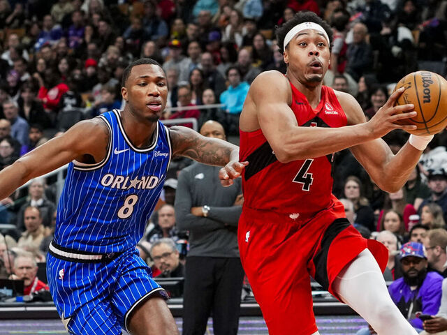 TORONTO, CANADA - MARCH 29: Scottie Barnes #4 of the Toronto Raptors drives to the basket against Jamal Cain #8 of the Orlando Magic during the second half at Scotiabank Arena on March 29, 2026 in Toronto, Canada.