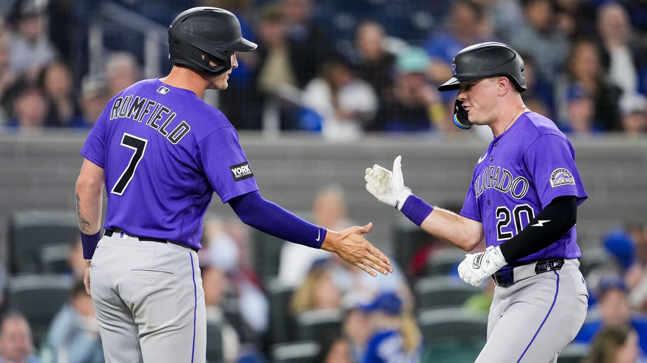 TORONTO, CANADA - MARCH 30: Troy Johnston #20 of the Colorado Rockies celebrates a two run home run with TJ Rumfield #7 against the Toronto Blue Jays during the sixth inning in their MLB game at the Rogers Centre on March 30, 2026 in Toronto, Ontario, Canada.