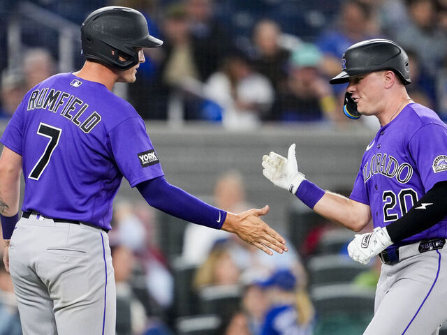 TORONTO, CANADA - MARCH 30: Troy Johnston #20 of the Colorado Rockies celebrates a two run home run with TJ Rumfield #7 against the Toronto Blue Jays during the sixth inning in their MLB game at the Rogers Centre on March 30, 2026 in Toronto, Ontario, Canada.