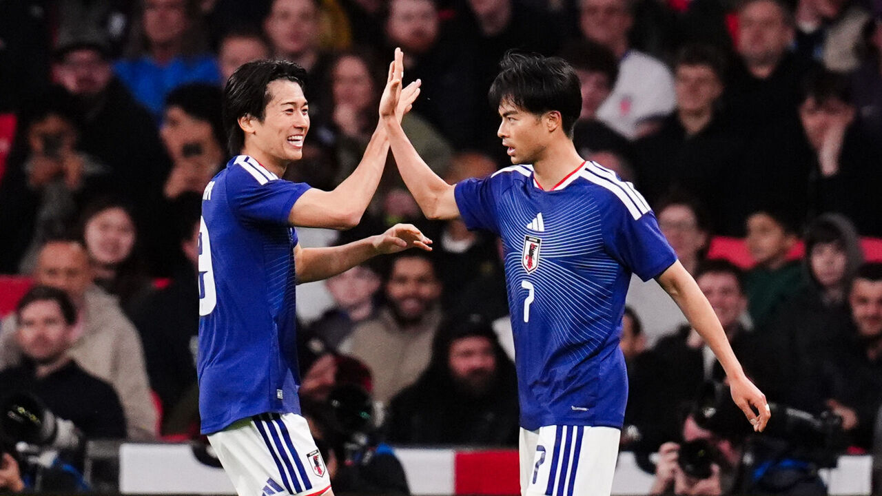 Japan's Kaoru Mitoma (right) celebrates scoring the opening goal during the international friendly match at Wembley Stadium, London. Picture date: Tuesday March 31, 2026.