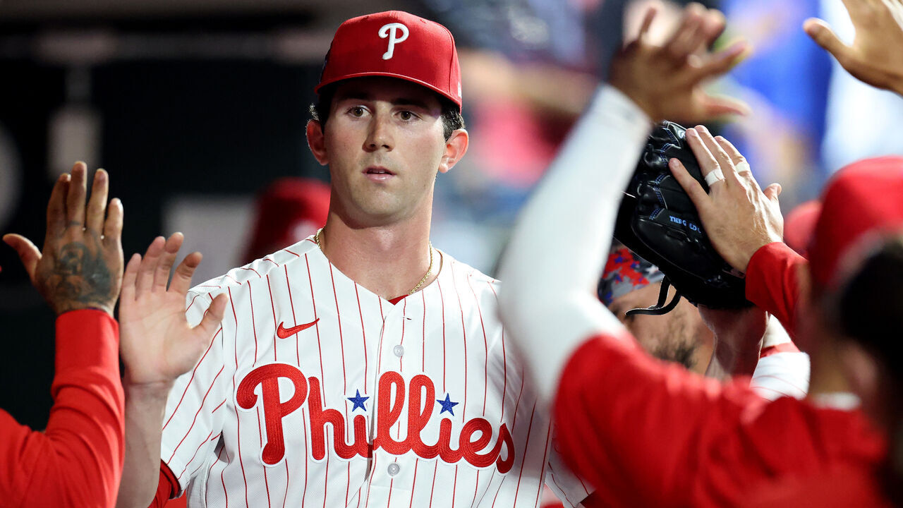 PHILADELPHIA, PENNSYLVANIA - MARCH 31: Andrew Painter #24 of the Philadelphia Phillies high fives teammates in the dugout after being relieved in the sixth inning during his MLB debut against the Washington Nationals at Citizens Bank Park on March 31, 2026 in Philadelphia, Pennsylvania.