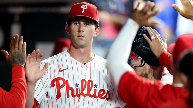 PHILADELPHIA, PENNSYLVANIA - MARCH 31: Andrew Painter #24 of the Philadelphia Phillies high fives teammates in the dugout after being relieved in the sixth inning during his MLB debut against the Washington Nationals at Citizens Bank Park on March 31, 2026 in Philadelphia, Pennsylvania.