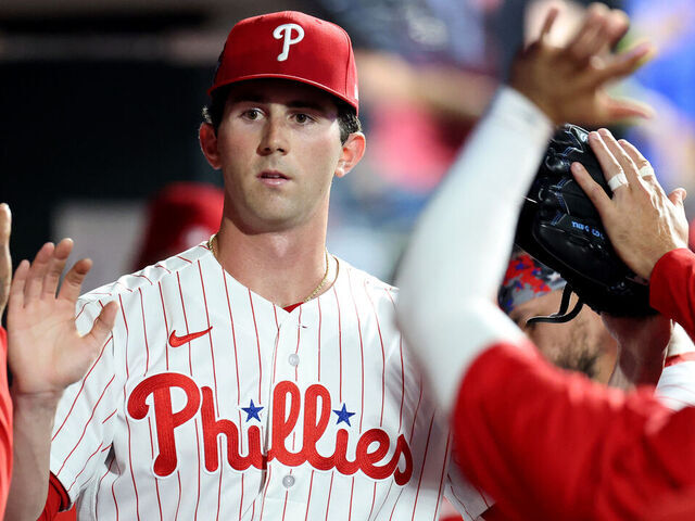 PHILADELPHIA, PENNSYLVANIA - MARCH 31: Andrew Painter #24 of the Philadelphia Phillies high fives teammates in the dugout after being relieved in the sixth inning during his MLB debut against the Washington Nationals at Citizens Bank Park on March 31, 2026 in Philadelphia, Pennsylvania.
