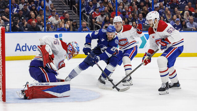 TAMPA, FL - MARCH 31: Zemgus Girgensons #28 of the Tampa Bay Lightning battles for the puck against goalie Jakub Dobes #75, Cole Caufield #13, and Noah Dobson #53 of the Montreal Canadiens at Benchmark International Arena on March 31, 2026 in Tampa, Florida.