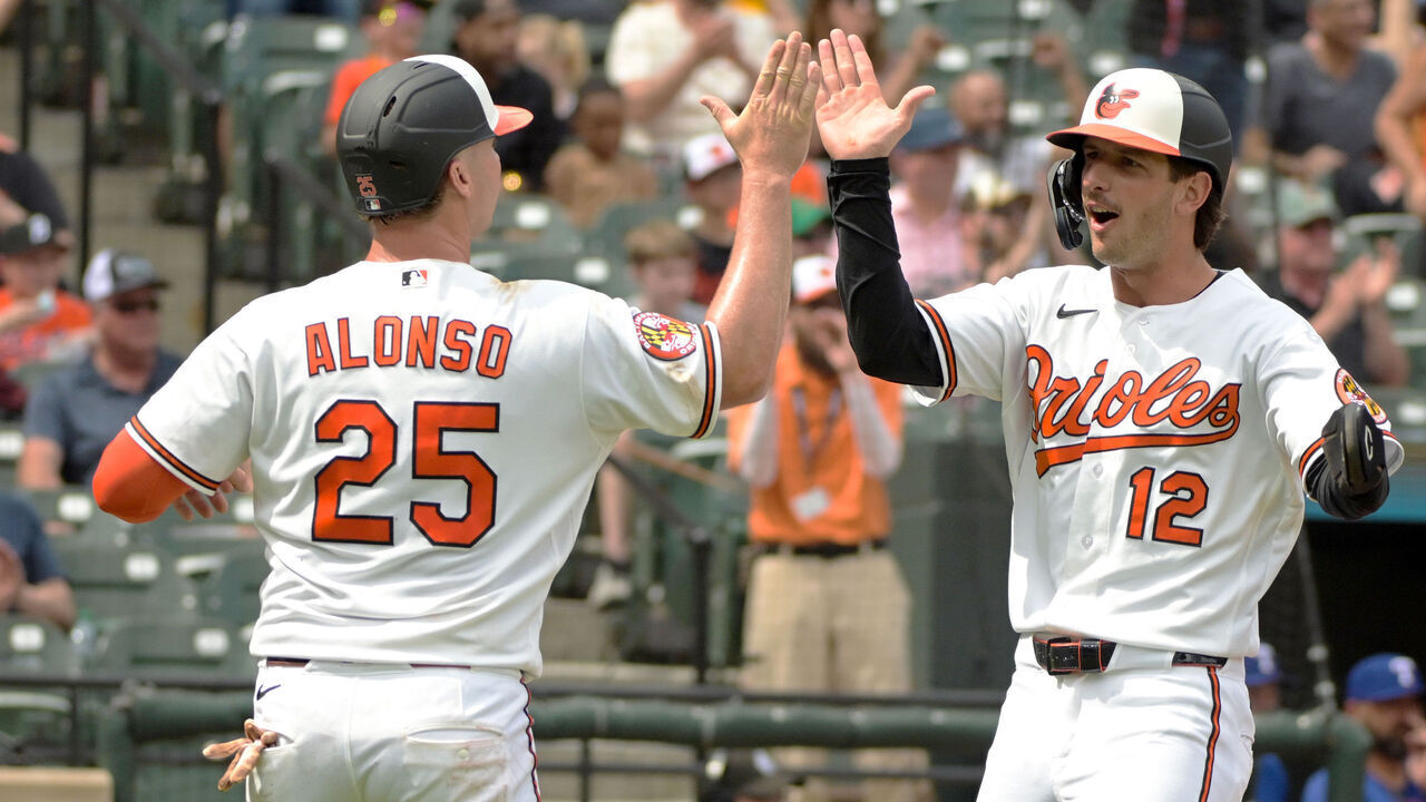 BALTIMORE, MD - APRIL 01: Baltimore Orioles right fielder Dylan Beavers (12) is congratulated by first baseman Pete Alonso (25) after scoring during the game between the Texas Rangers and the Baltimore Orioles on April 01, 2026 at Oriole Park at Camden Yards in Baltimore, MD.