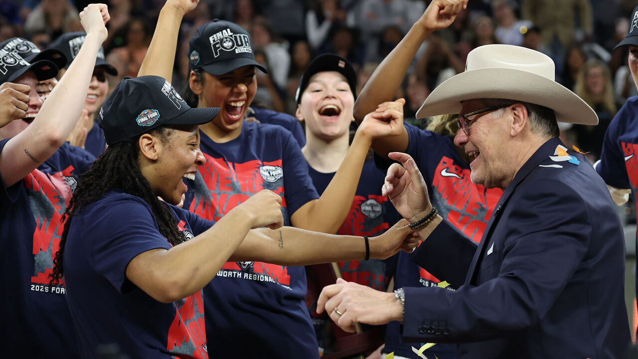 FORT WORTH, TEXAS - MARCH 29: Kk Arnold #2 of the UConn Huskies putts a cowboy hat on head coach Geno Auriemma of the UConn Huskies after defeating the Notre Dame Fighting Irish 70-52in the Elite Eight of the 2026 NCAA Women's Basketball Tournament at Dickies Arena on March 29, 2026 in Fort Worth, Texas.