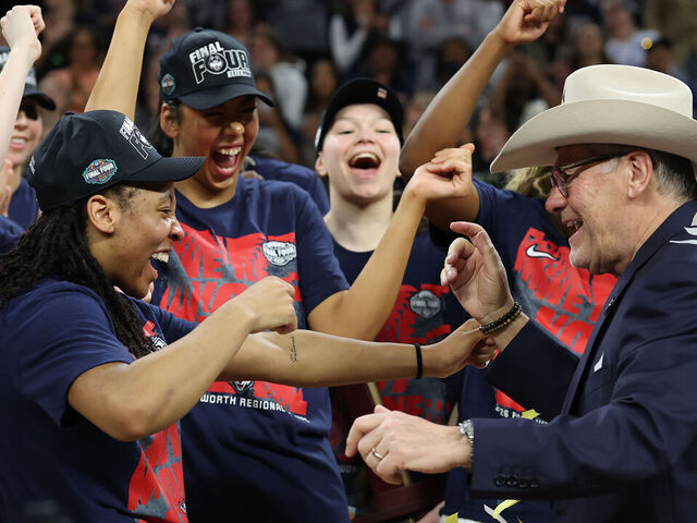 FORT WORTH, TEXAS - MARCH 29: Kk Arnold #2 of the UConn Huskies putts a cowboy hat on head coach Geno Auriemma of the UConn Huskies after defeating the Notre Dame Fighting Irish 70-52in the Elite Eight of the 2026 NCAA Women's Basketball Tournament at Dickies Arena on March 29, 2026 in Fort Worth, Texas.