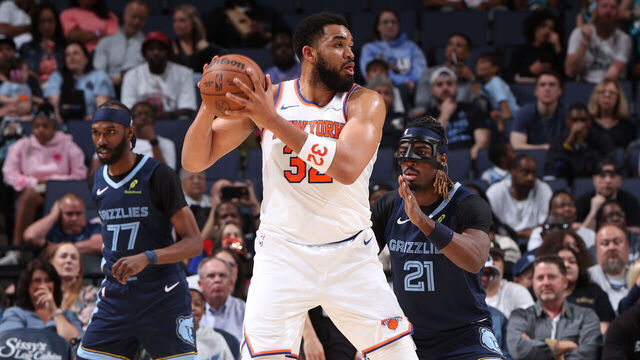 MEMPHIS, TN - APRIL 1: Karl-Anthony Towns #32 of the New York Knicks looks to pass the ball as Ryan Rupert #21 of the Memphis Grizzlies plays defense during the game on April 1, 2026 at FedExForum in Memphis, Tennessee. Mandatory Copyright Notice: Copyright 2026 NBAE