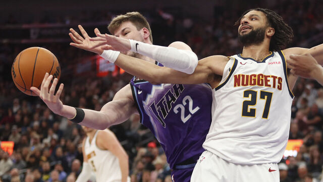 SALT LAKE CITY, UT - APRIL 1: Kyle Filipowski #22 of the Utah Jazz fights for a rebound with Jamal Murray #27 of the Denver Nuggets during the first half of their game at the Delta Center on April 1, 2026 in Salt Lake City, Utah.