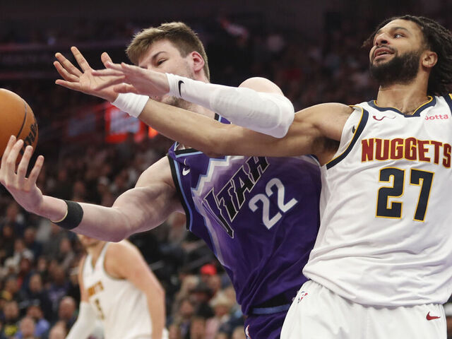 SALT LAKE CITY, UT - APRIL 1: Kyle Filipowski #22 of the Utah Jazz fights for a rebound with Jamal Murray #27 of the Denver Nuggets during the first half of their game at the Delta Center on April 1, 2026 in Salt Lake City, Utah.