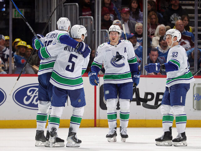 DENVER, COLORADO - APRIL 01: Elias Pettersson #25, Tom Willander #5, Brock Boeser #6 and Marco Rossi #93 of the Vancouver Canucks celebrate after a goal against the Colorado Avalanche at Ball Arena on April 1, 2026 in Denver, Colorado.